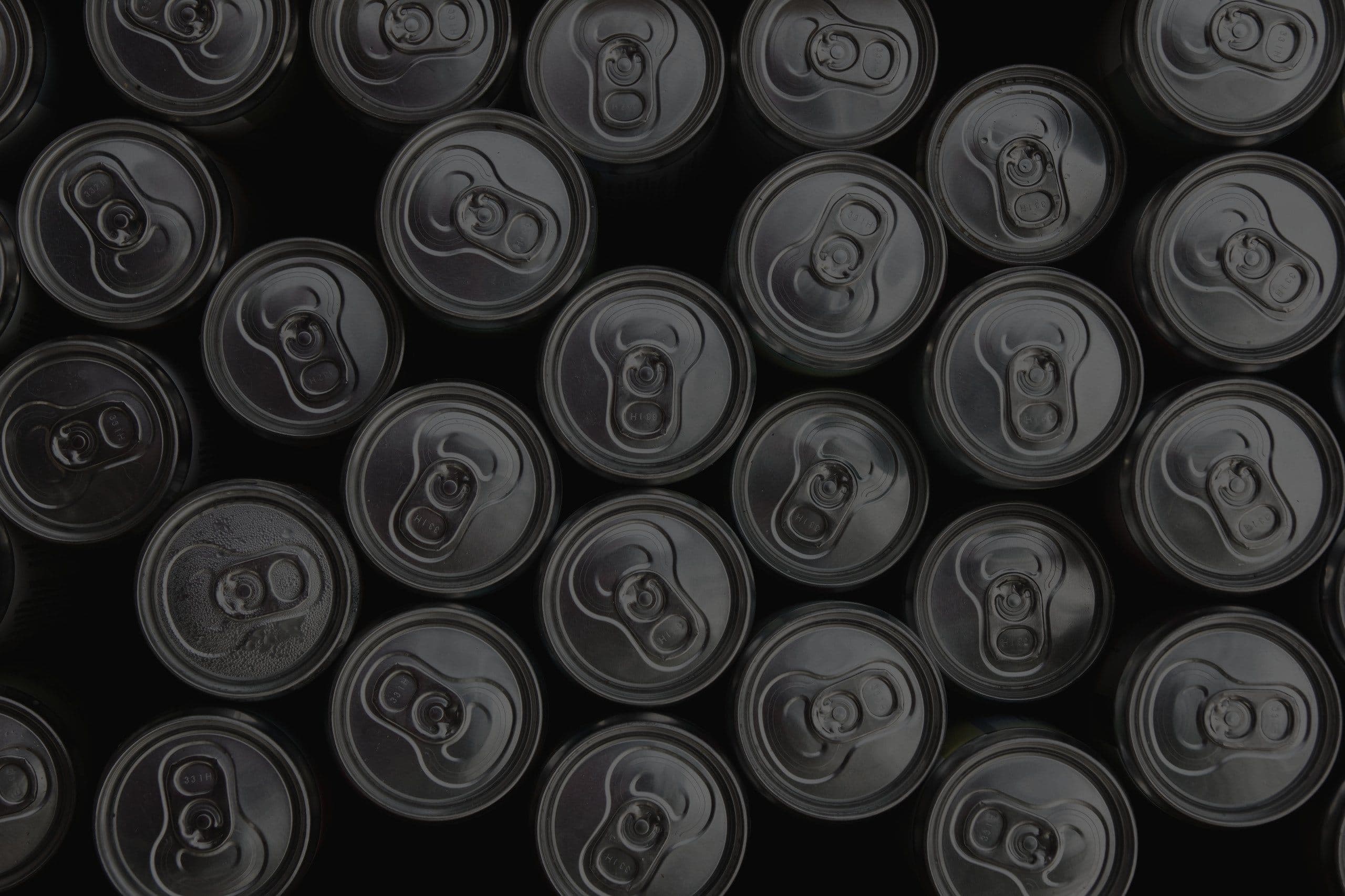 Unbranded aluminium can lids seen from above, packed in a tight pattern