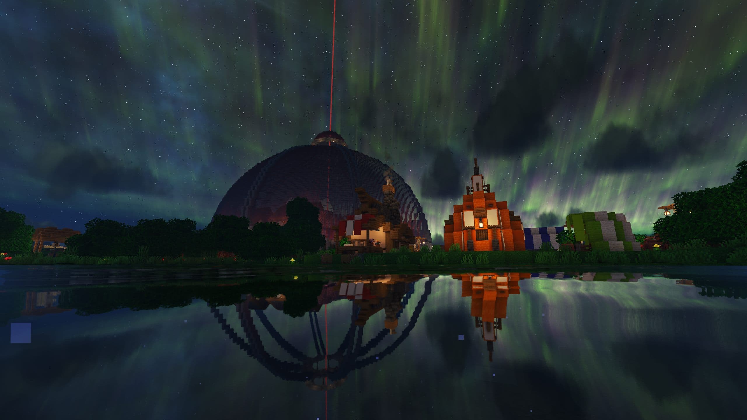 The community's Minecraft world at night, a domed build reflected in the water under an aurora